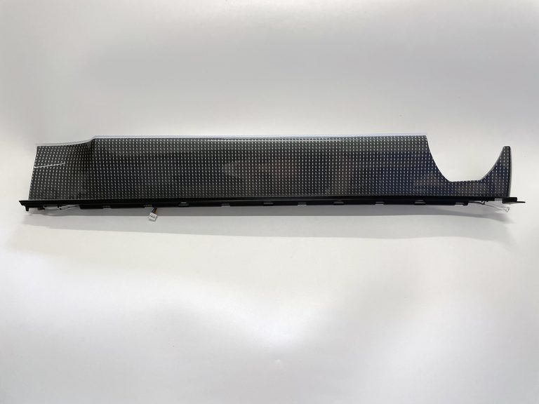Illuminated passenger-side dashboard trim